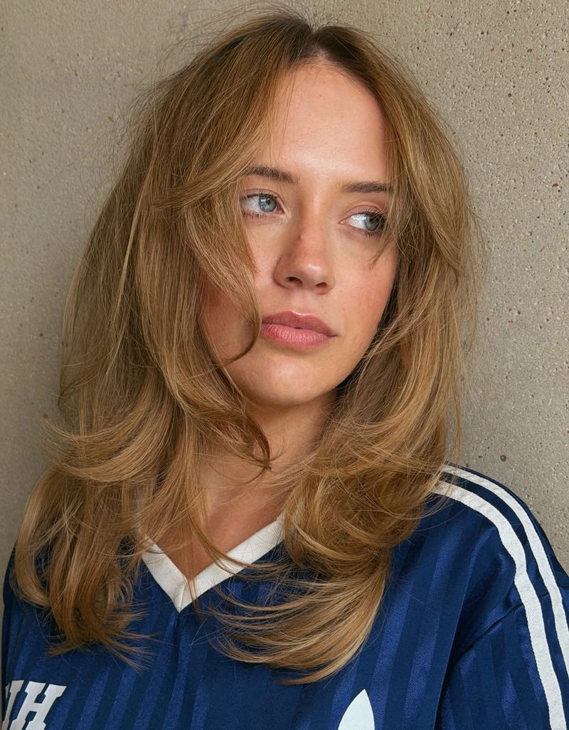 39. Soft Blonde Blowout with Curtained Bangs