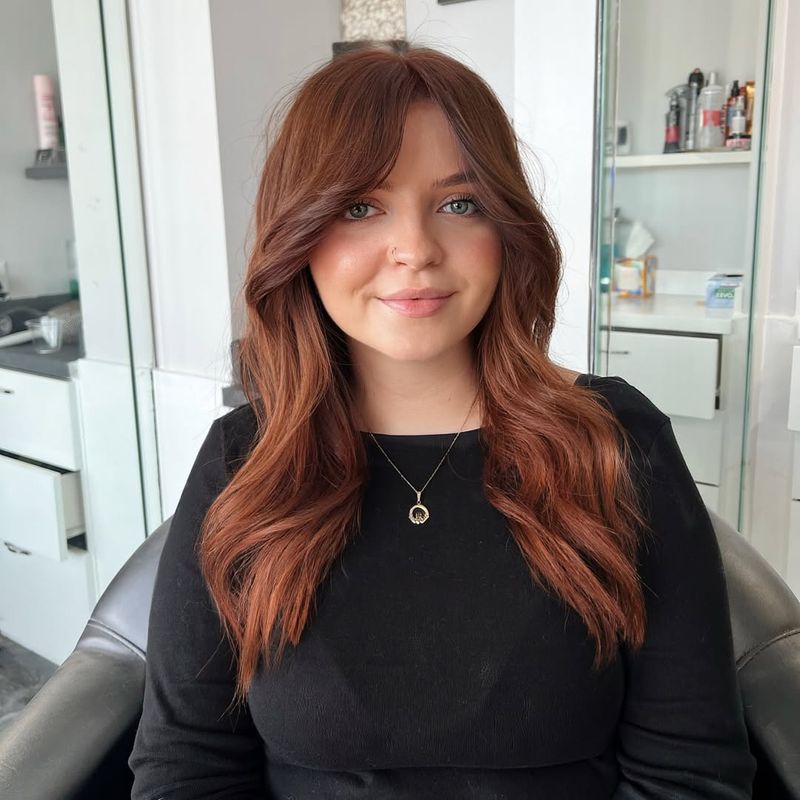 29. Soft Chestnut Waves and Curtain Bangs