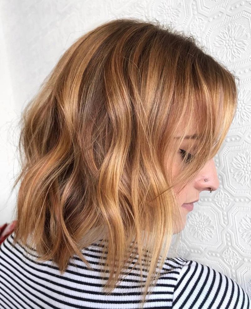 19. Soft Peachy Waves and Side-Swept Bangs