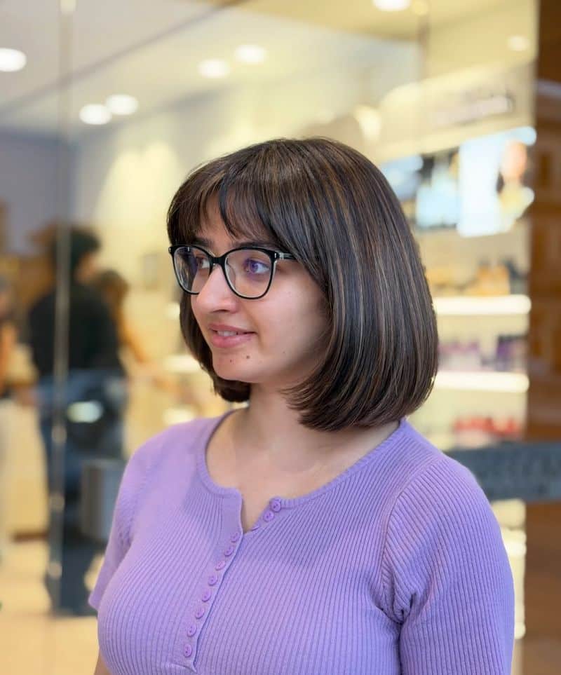 11. Subtle Caramel Highlights on a Rounded Bob with Bangs