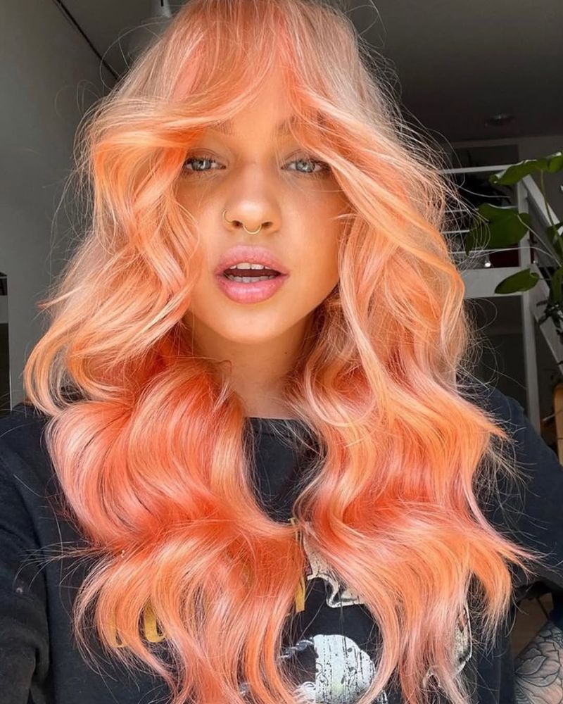 10. Sunset Peach Curtain Bangs