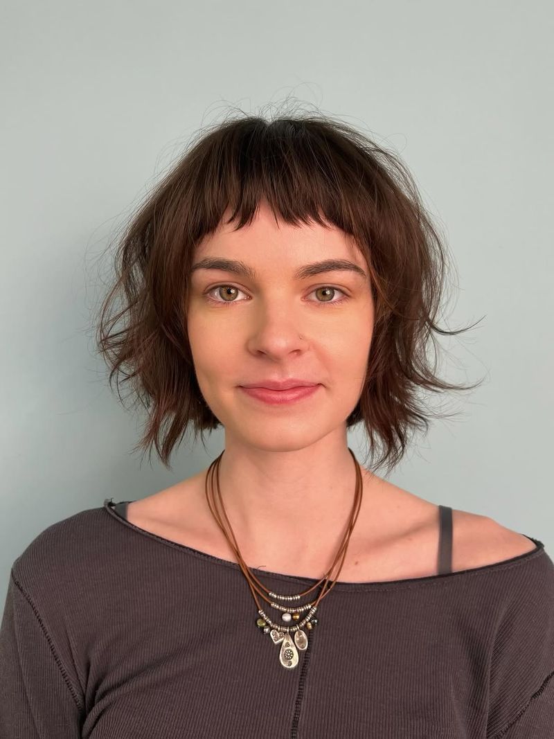 42. Tousled Brunette Bob with Baby Bangs