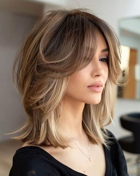 8. Tousled Chestnut Lob with Curtain Bangs