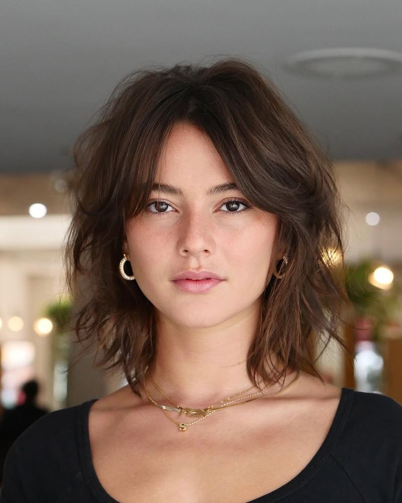 30. Tousled Chestnut Shag with Curtain Bangs