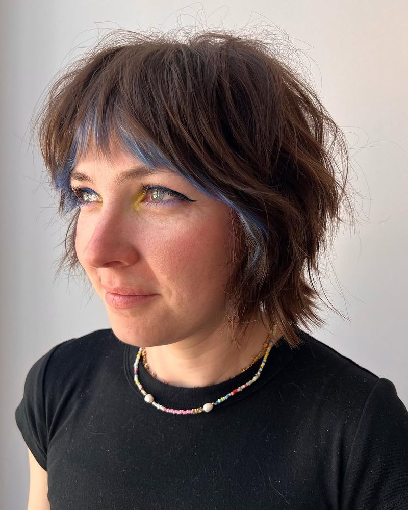 25. Tousled Shag with Electric Blue Peekaboo Bangs