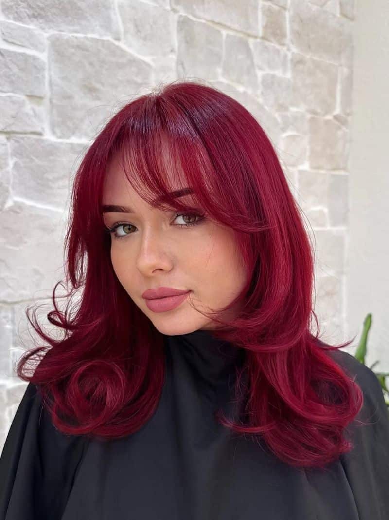 15. Velvet Berry Blowout with Curtain Bangs