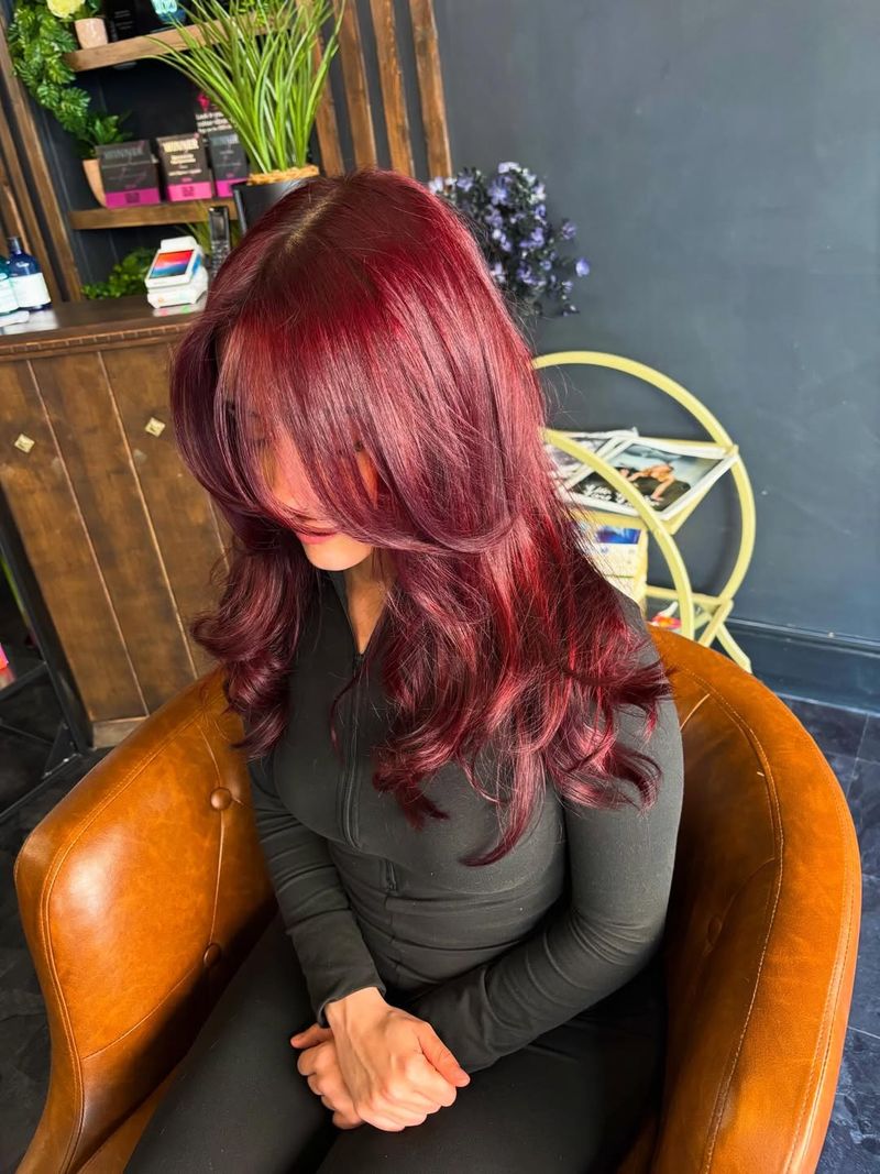 12. Velvet Ruby Layers with Curtain Bangs