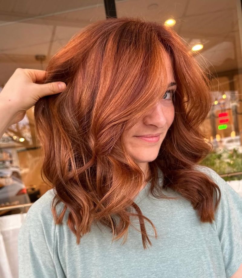 16. Vibrant Auburn Waves with Soft Curtain Fringe