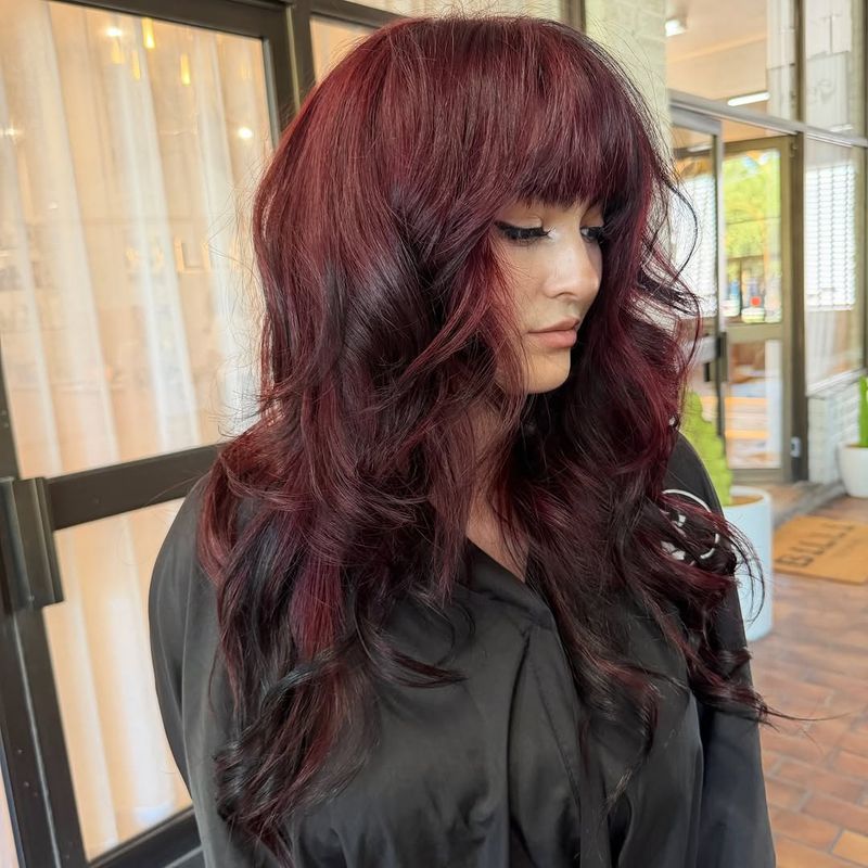 51. Voluminous Black Cherry Layers with Heavy Bangs