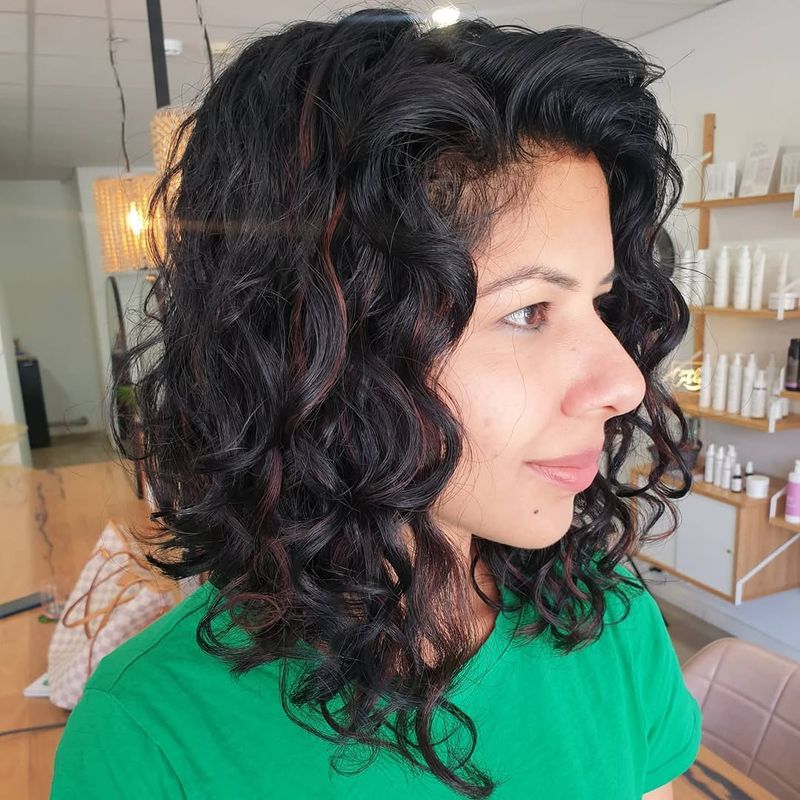 31. Voluminous Jet-Black Shoulder-Length Curls