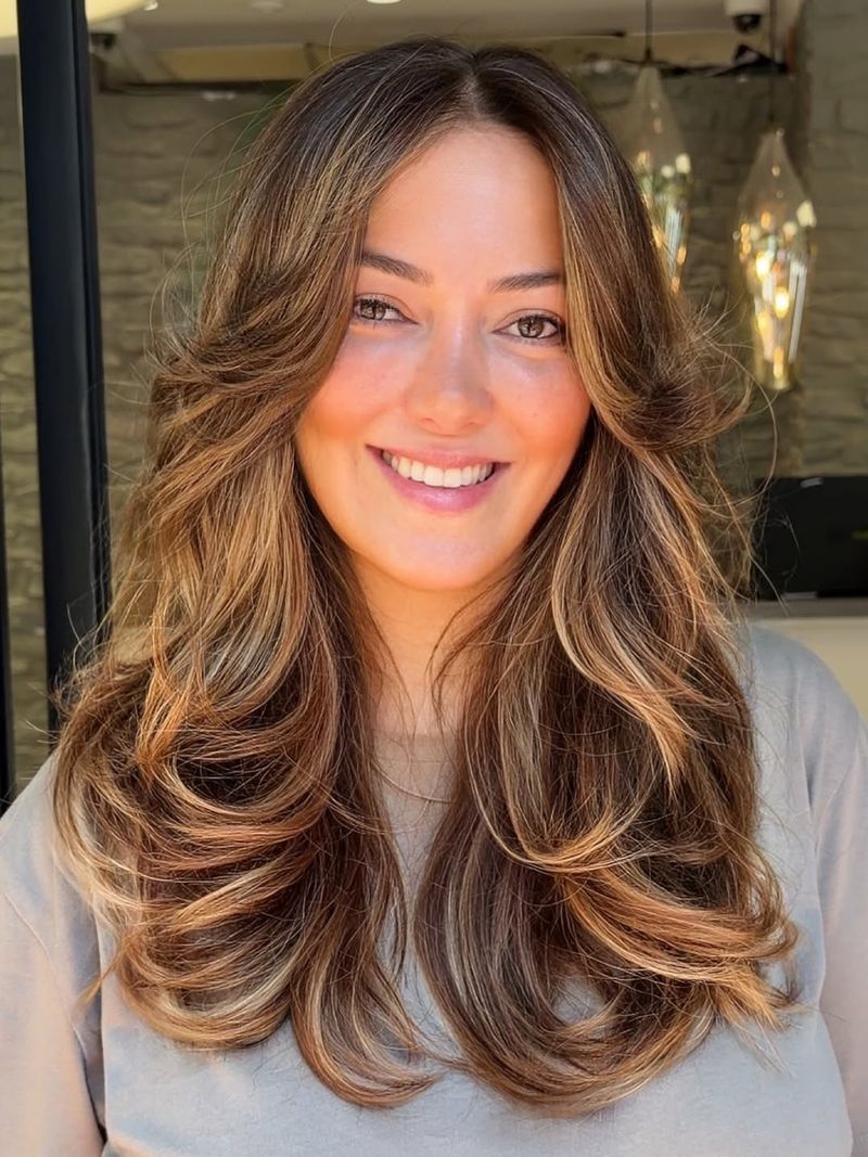 36. Warm Caramel Layers with Voluminous Sweeping Bangs