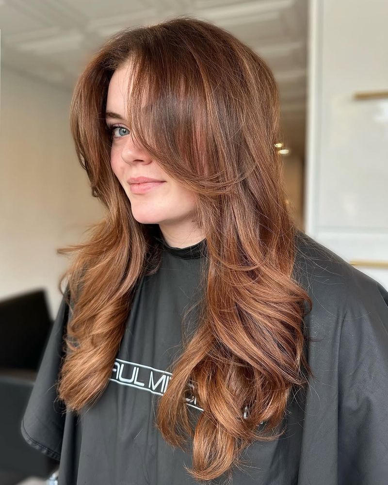 29. Warm Cinnamon Layers with Long Curtain Bangs