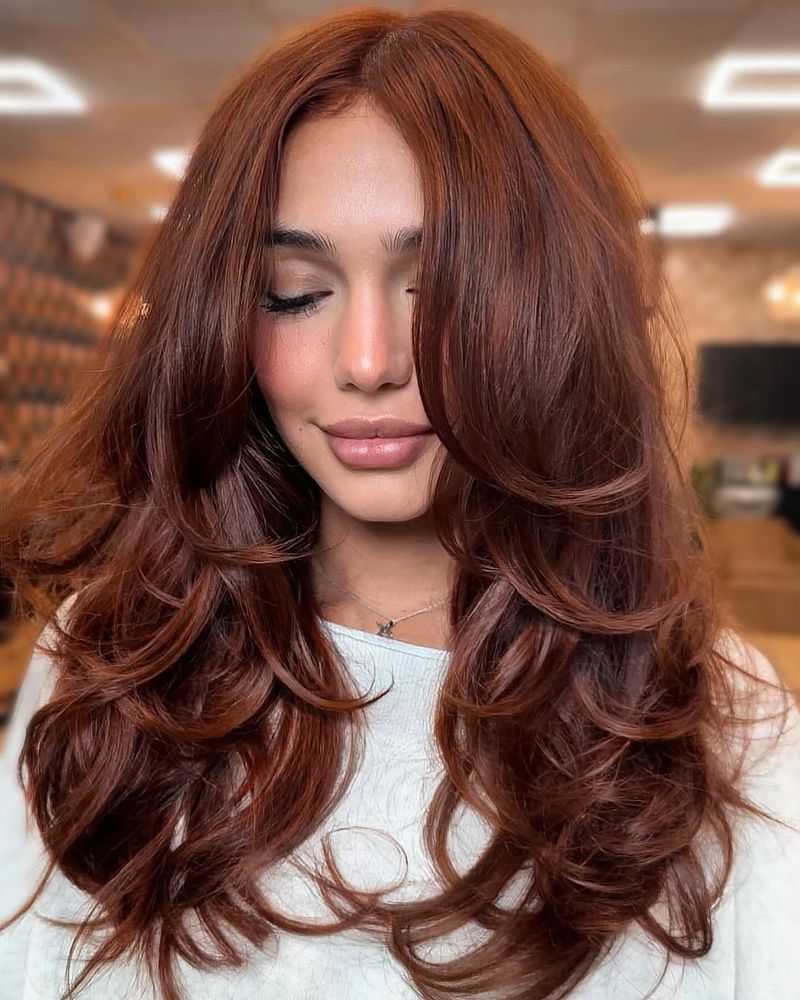 18. Warm Spiced Layers with Curtain Bangs